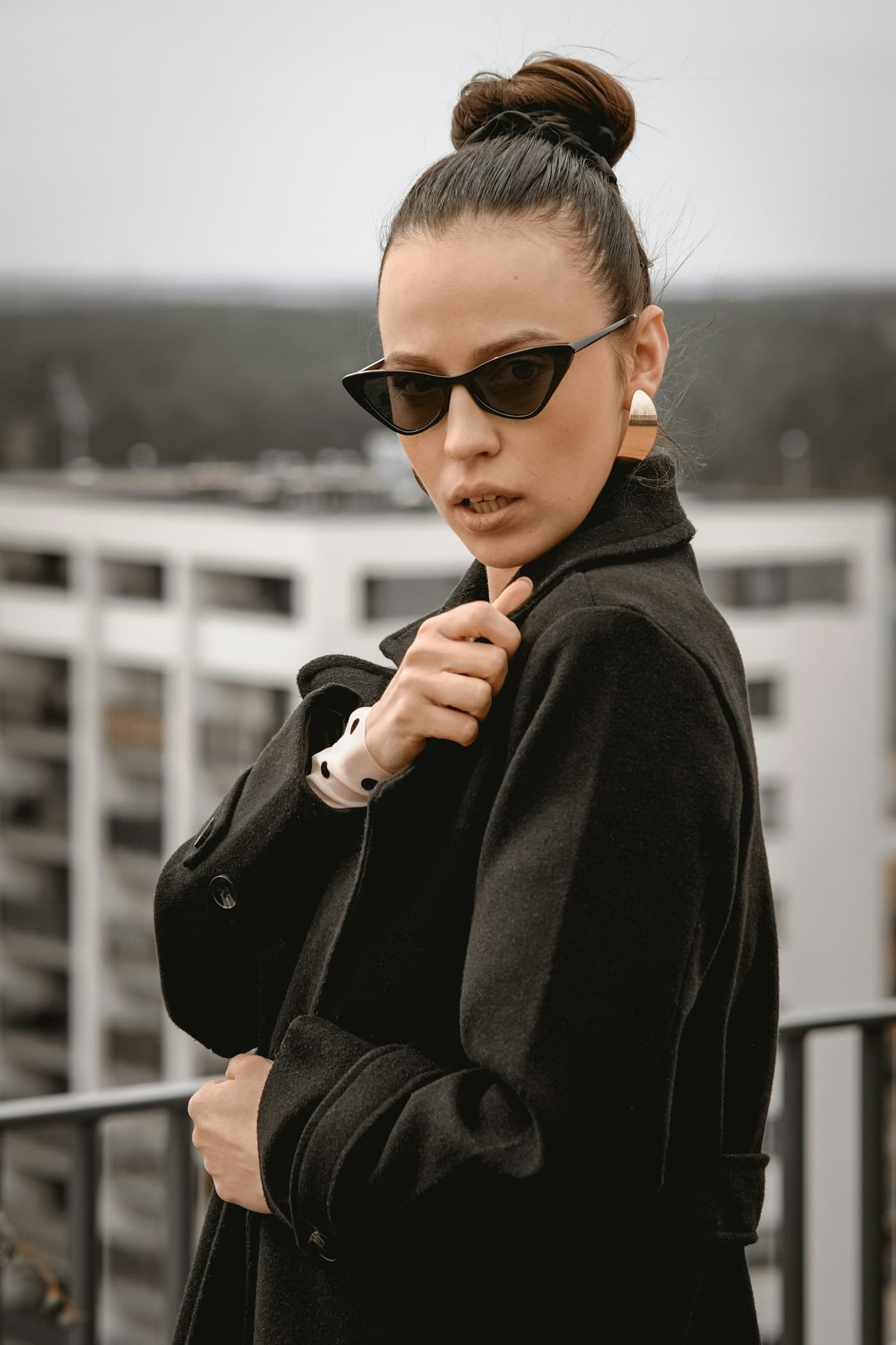 Portrait in black cat-eye sunglasses with a sharply upswept temple