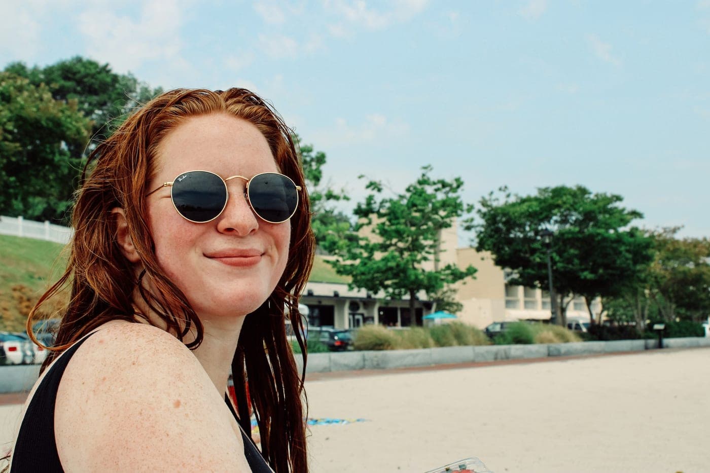 Portrait in daylight wearing thin gold round metal sunglasses